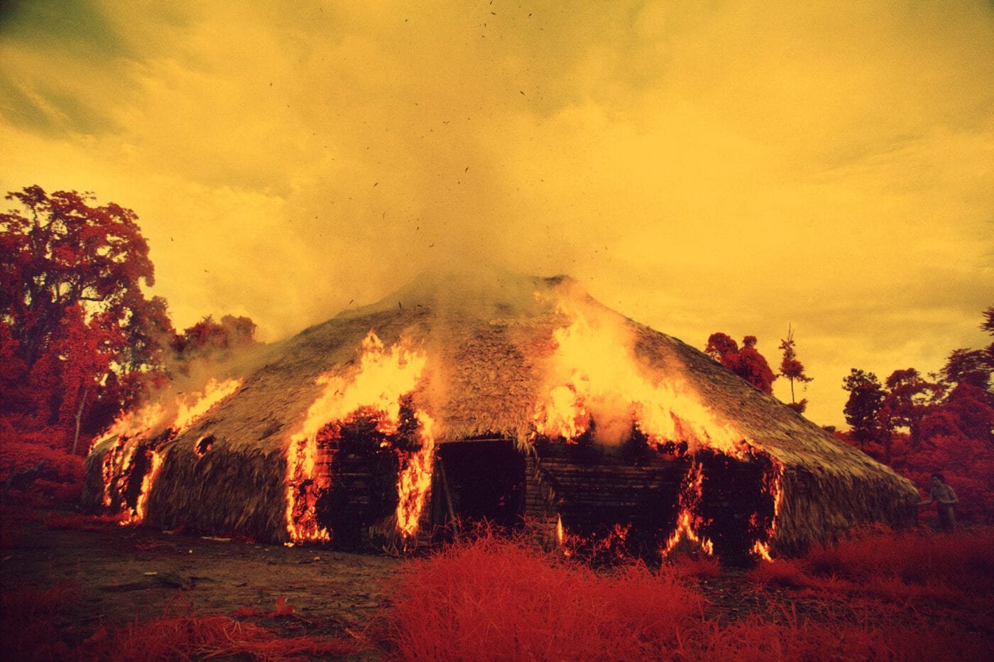 The Yanomami often burn down their yano [collective house] when they migrate, when they want to escape from an epidemic, or when an important leader dies. Catrimani, 1972-76. Infrared film. © Claudia Andujar 